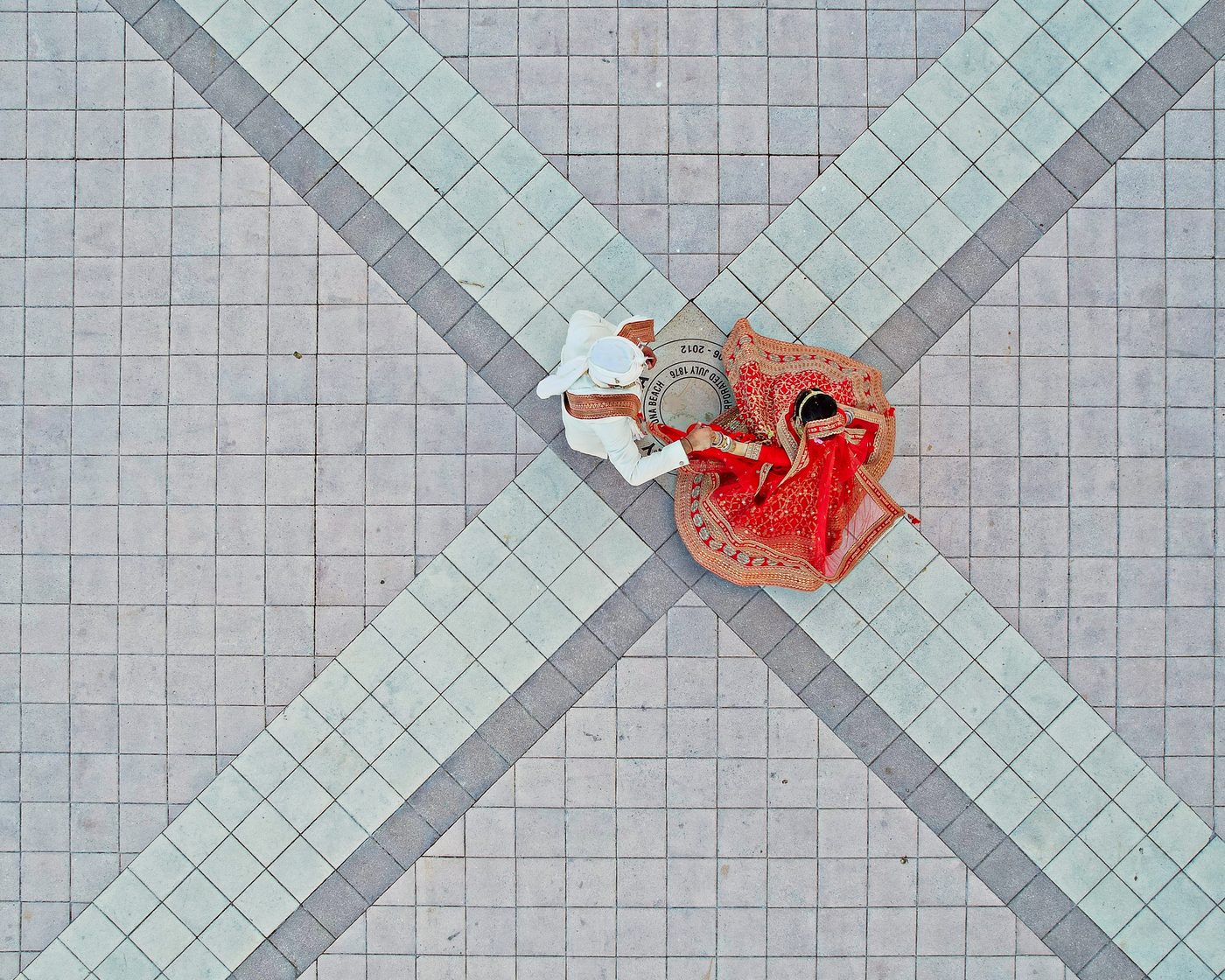 An aerial view of a couple on a tiled courtyard